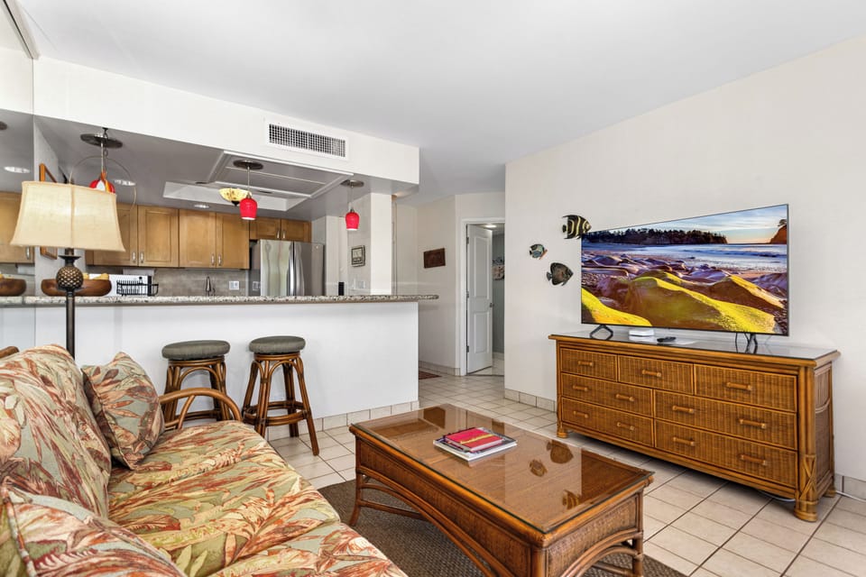 Your island getaway awaits in this inviting open-plan space where warm wood and vibrant tropical tones meet modern comfort. Relax in the living area or gather at the breakfast bar for ocean views and breezy island living.