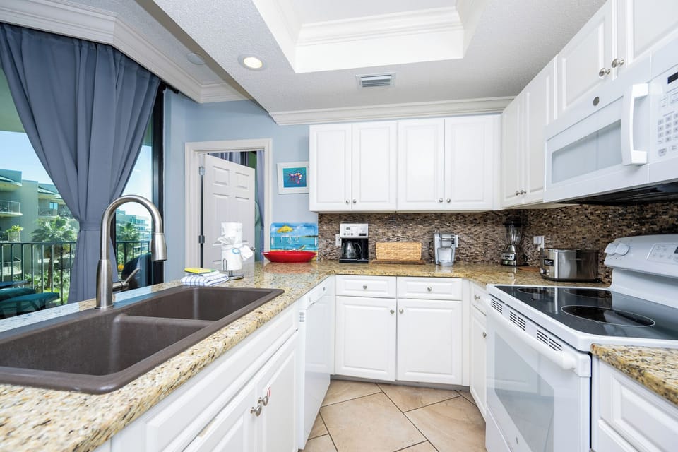 Craft your favorite meals in the kitchen, enjoying the coastal light streaming through the window