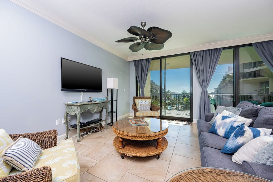 Unwind in the family room, soaking in warm coastal sunlight and gentle breezes while enjoying a favorite show