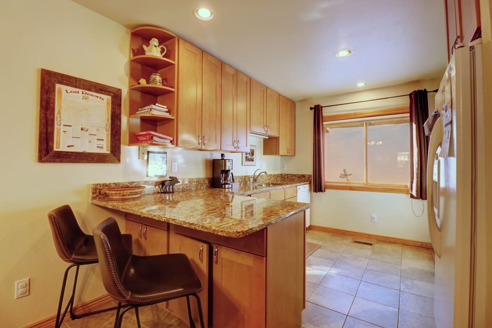 Open concept kitchen area with a couple of spots for seating at the counter.