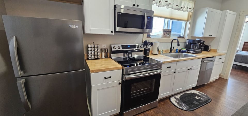 Modern kitchen with stainless steel appliances, ample counter space, coffee station, and everything needed to prepare meals during your stay.