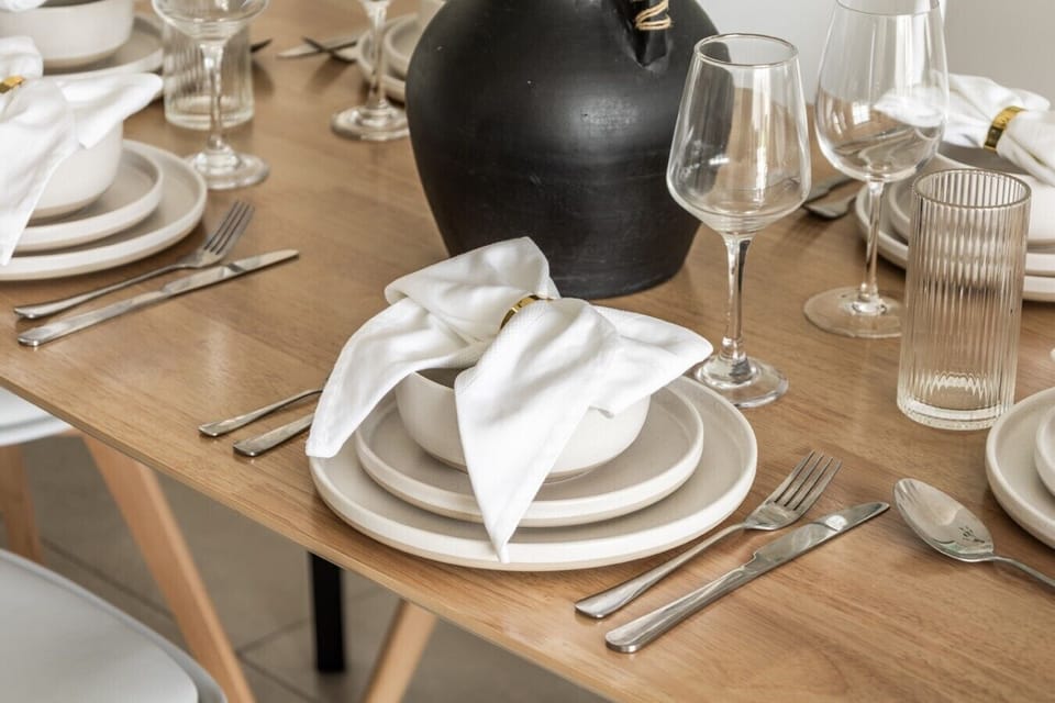 Dining table set for six with elegant place settings