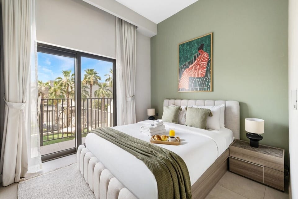 Bedroom with balcony and palm tree view