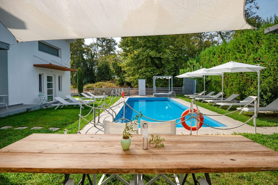 Pool area perspective from an outdoors patio