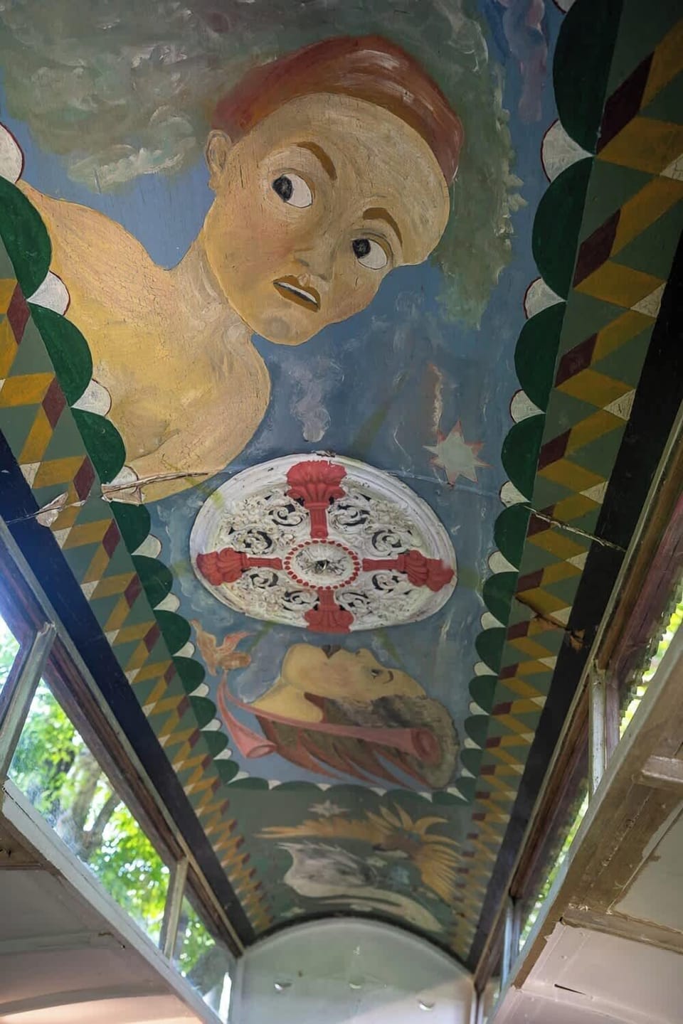 A playful painted ceiling inside the Gypsy caravan sleeping space, adding a fun and memorable touch to this unique pet-friendly Bangalow stay.
