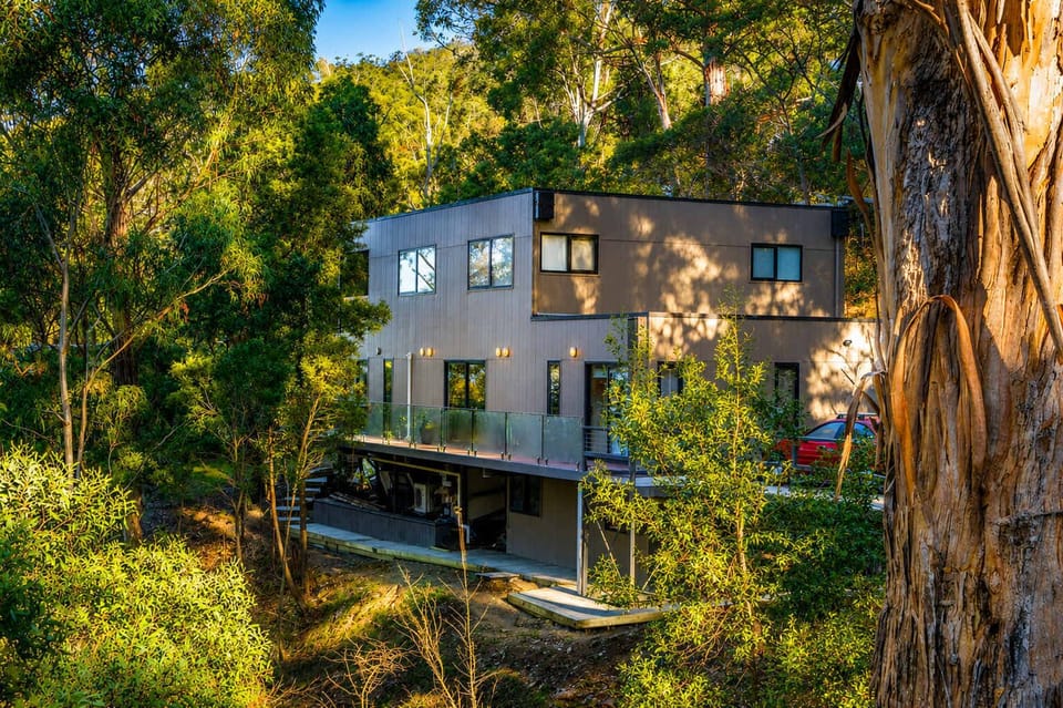 A contemporary two-storey home surrounded by established native bushland in peaceful Taroona.