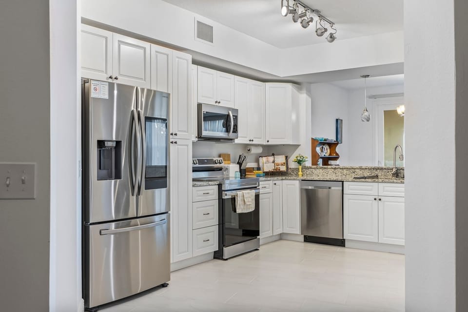 Modern kitchen with stainless steel appliances and granite countertops
