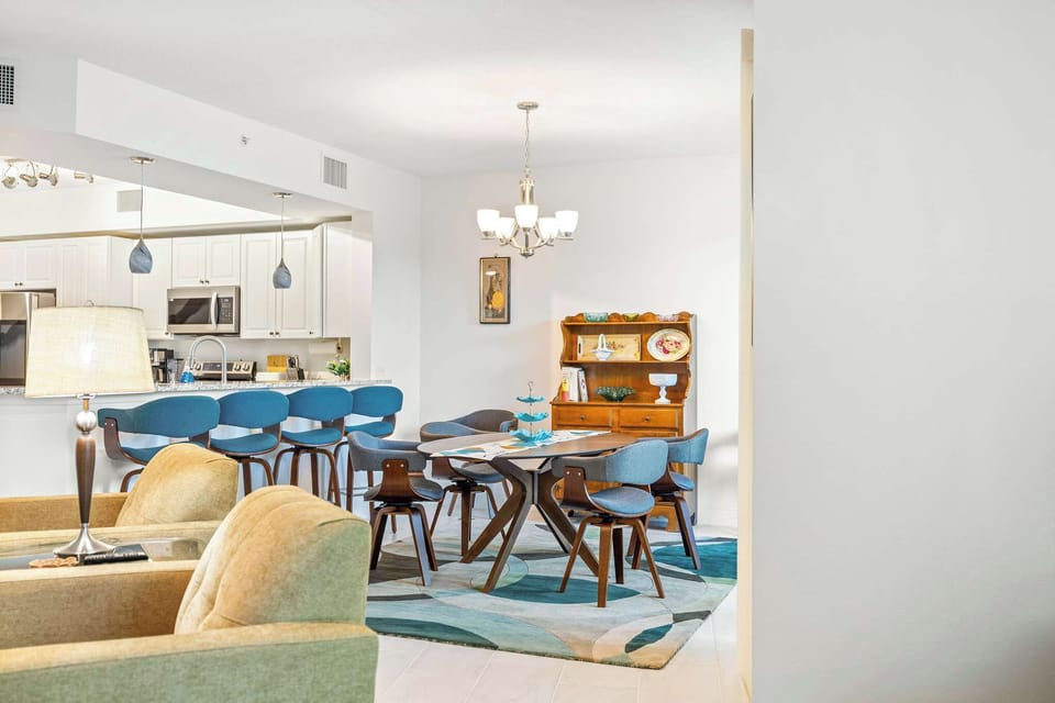 Open dining area with modern blue chairs and a wooden hutch for a cozy family meal setting