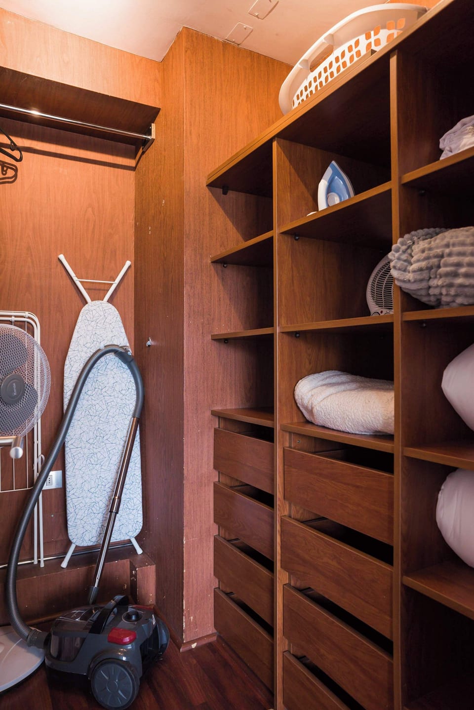 Convenient storage with essentials like an iron, vacuum, and more for a comfortable stay.