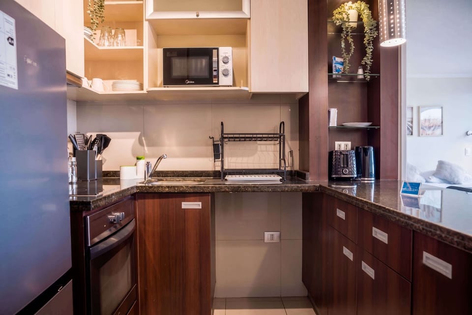 Modern kitchen with sleek appliances and ample storage, perfect for preparing meals during your stay.