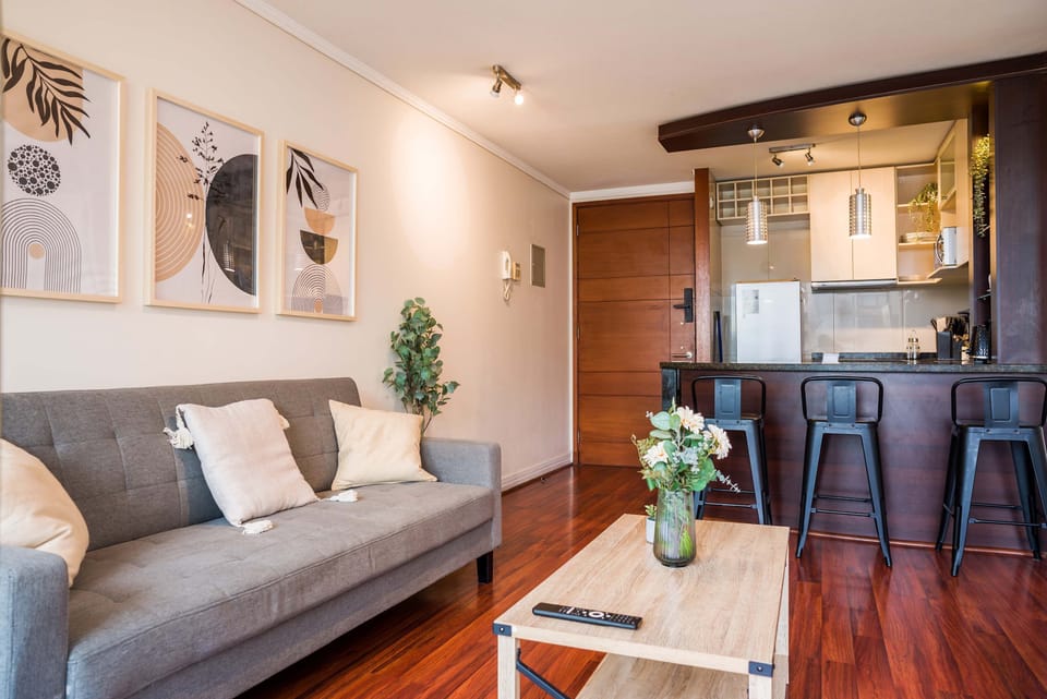 Stylish studio apartment with a cozy living area and modern kitchen, perfect for a comfortable stay in the heart of Chile.