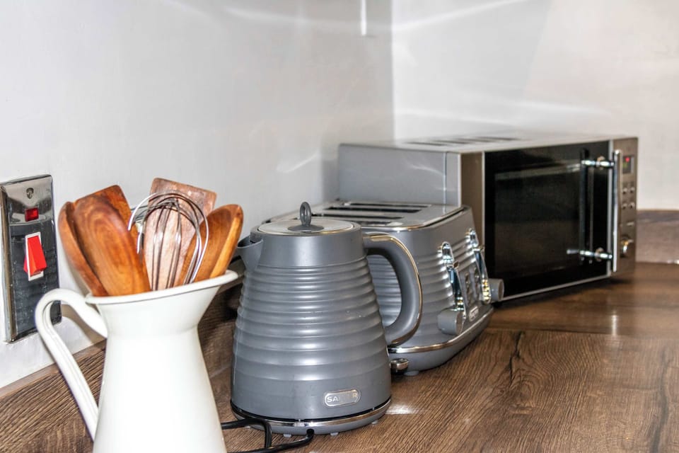 Fully equipped kitchen with kettle, microwave, toaster, and everything you need for a home-cooked meal