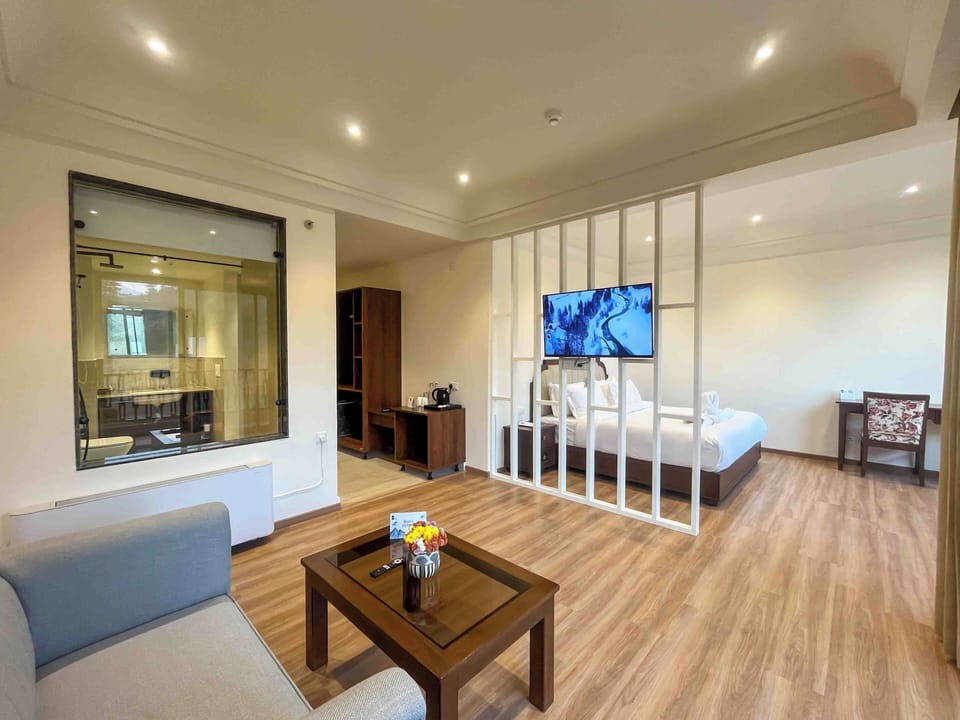 Deluxe Suite, Balcony, Mountain View | Living area | TV