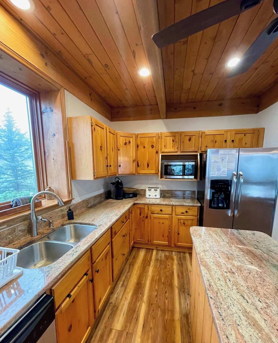Discover culinary excellence in our fully-outfitted kitchen adorned with solid wood cabinetry and granite counters. A space where style meets functionality, making every meal preparation a delightful experience.