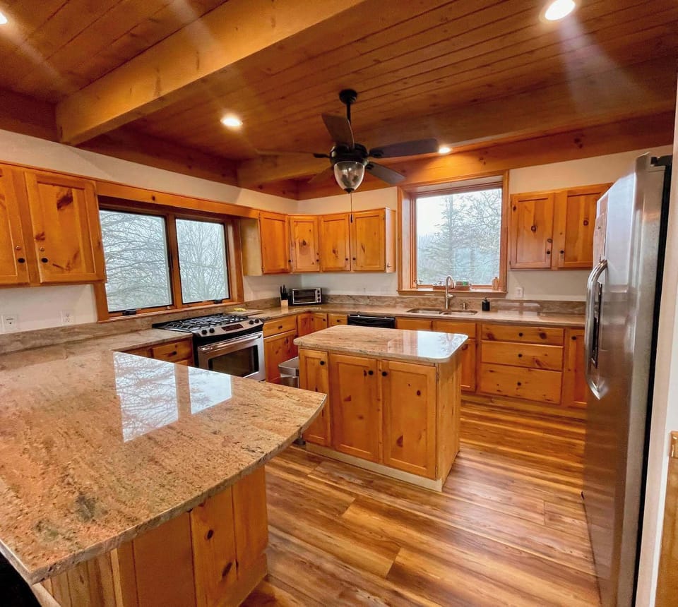 Step into the heart of our home, a fully-outfitted kitchen adorned with solid wood cabinetry and sleek granite counters. Where every meal becomes a masterpiece and every cooking experience is a joy.