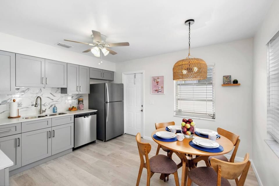 Head out the kitchen door to find the side patio complete with a grill, table, chairs, and lighting.