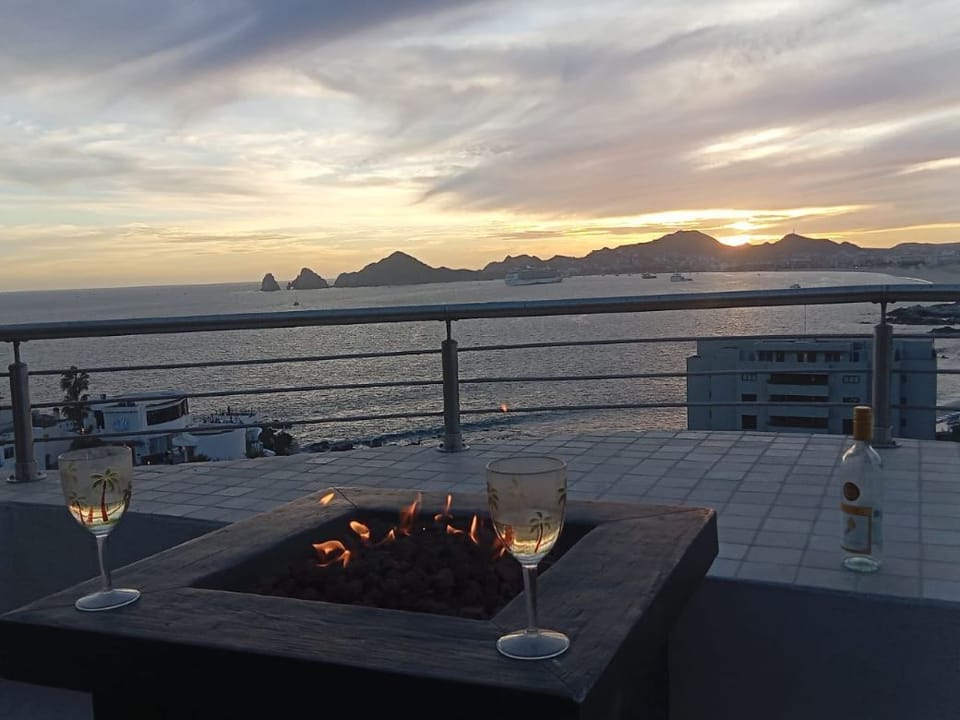 Enjoying a glass of wine with firepit lite at Sunset.