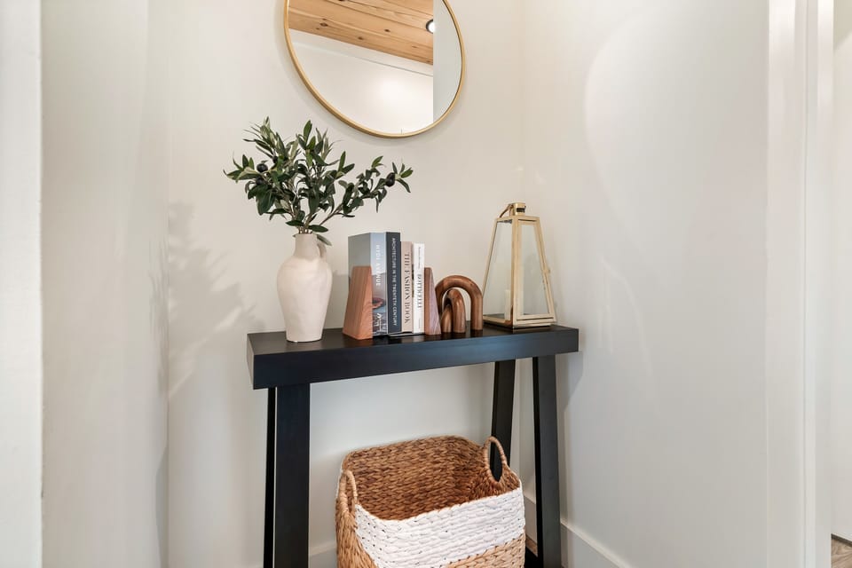 Gorgeous entryway table decorated with a vase, books and lantern!