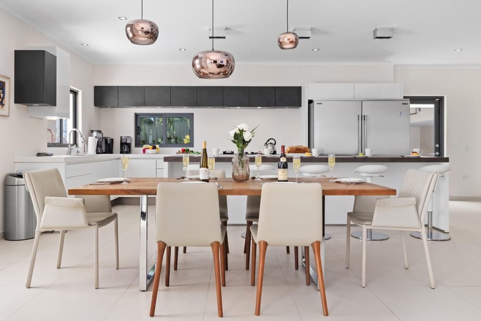 Gather around the spacious dining area, perfect for enjoying meals with family and friends in a warm, inviting atmosphere.