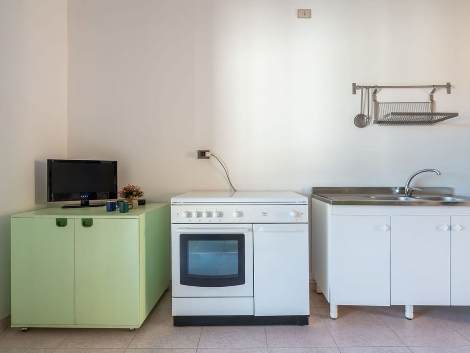 Flooring, Floor, Major Appliance, Interior Design, Kitchen, Kitchen Appliance, Cabinetry, Room, Furniture, Kitchen Stove