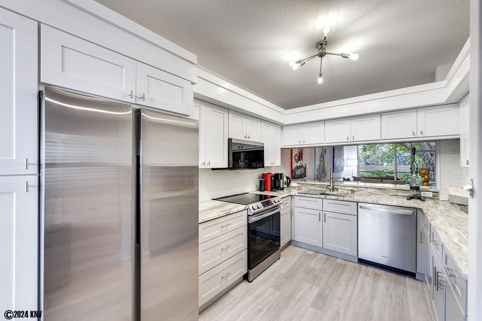 A fully equipped Designer Kitchen has white granite countertops and new everything! 