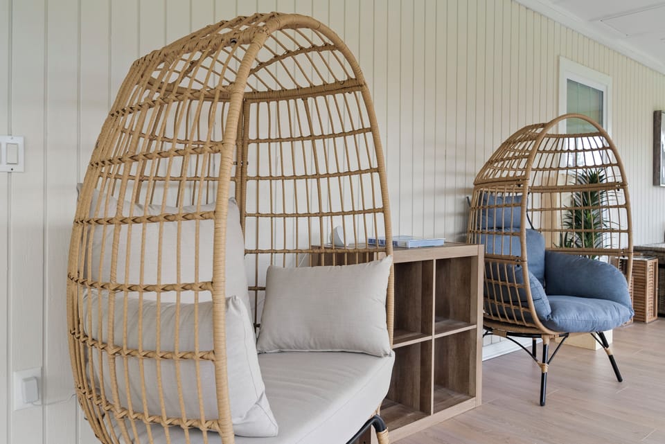 Peaceful sunroom with egg chairs—perfect for coffee, calm, or connection.