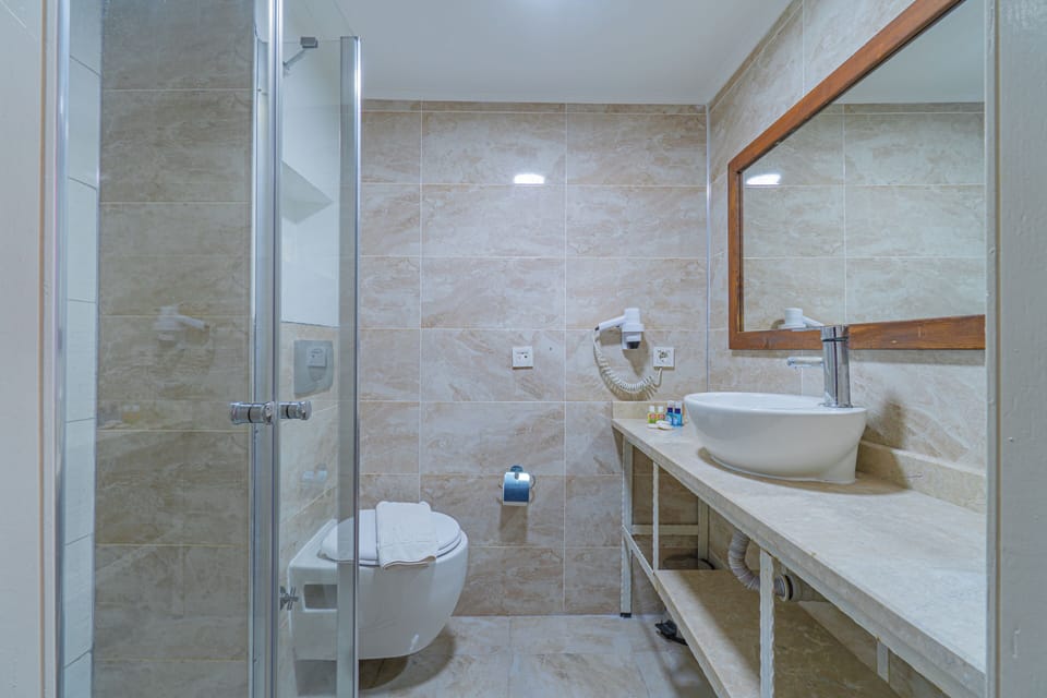 Shower, hair dryer, slippers, towels