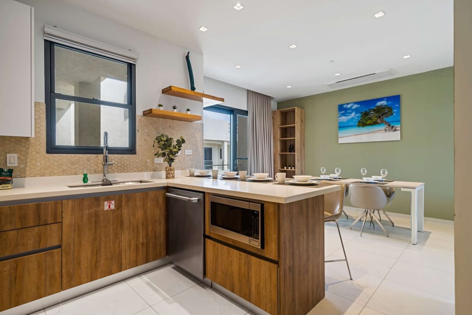 - Entertain effortlessly in this open kitchen and dining area, blending modern design with functionality - Warm wood tones and sleek finishes create a welcoming atmosphere - A versatile space perfect for hosting or casual family meals