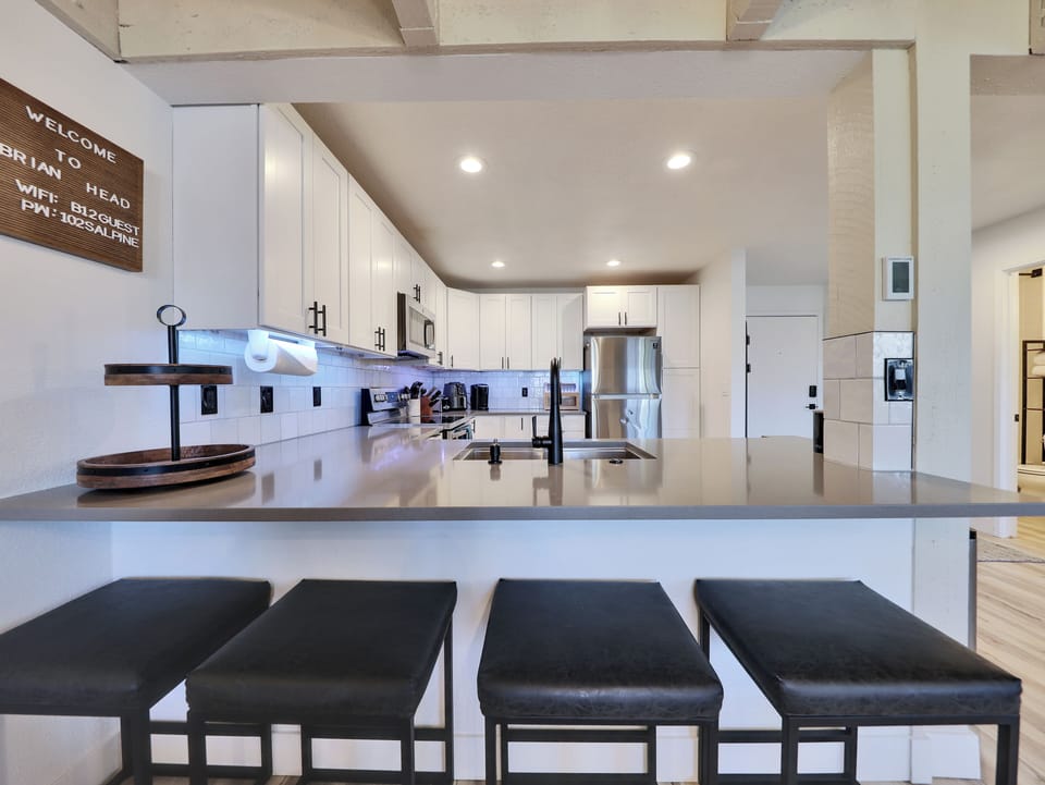 View of the newly remodeled kitchen with counter seating for four