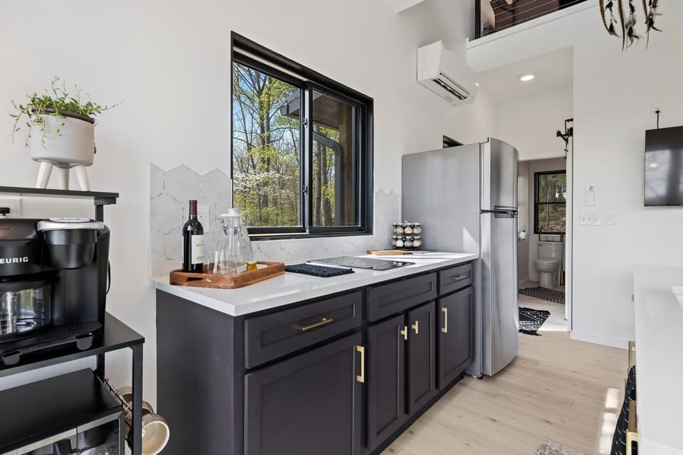 Kitchens are equipped with an induction cooktop, refrigerator, microwave, toaster oven and coffee maker.