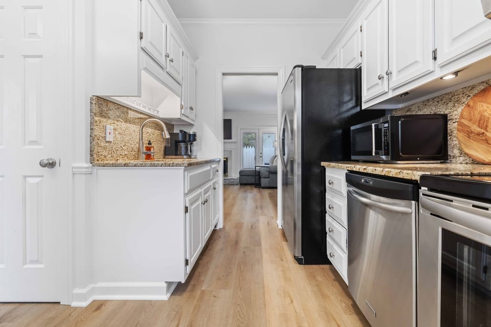 The kitchen, with its granite countertops, seamlessly opens into the dining room, creating a perfect space for cooking and gathering.