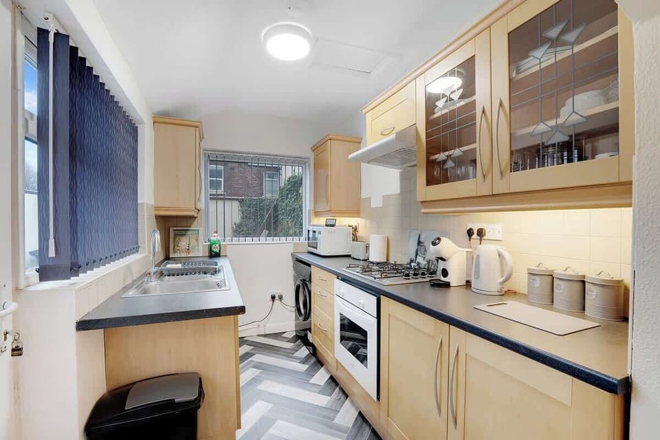 Kitchen equipped with all essentials, including a washer & dryer, oven, fridge and full cookware set.