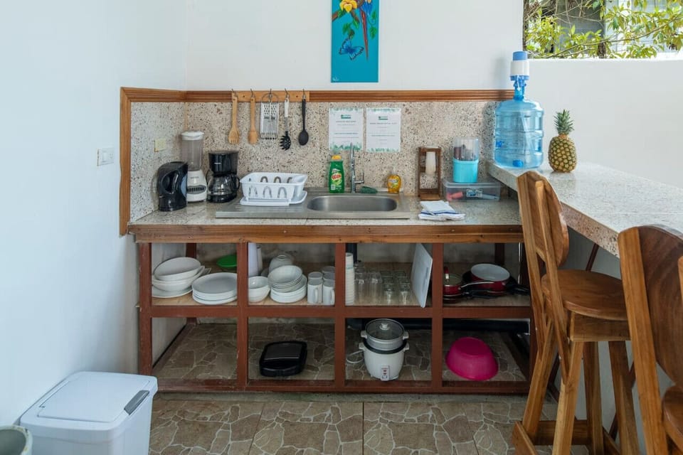 This fully equipped kitchen blends tropical charm with modern convenience, giving you everything you need to prepare delicious meals during your stay.