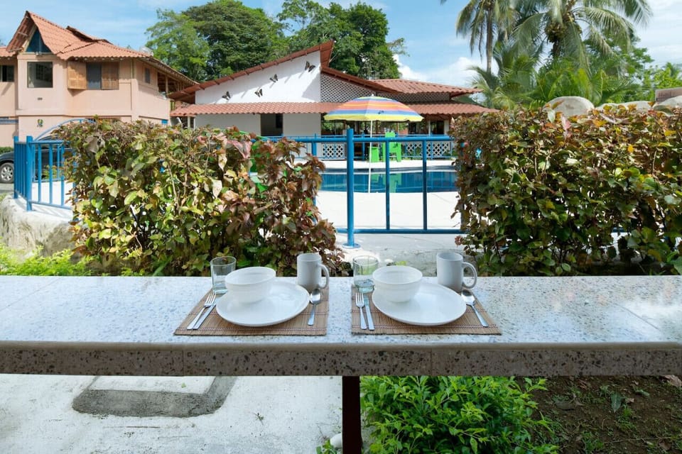 A peaceful outdoor setting for your morning coffee or tea, offering views of the serene pool area and tropical surroundings.