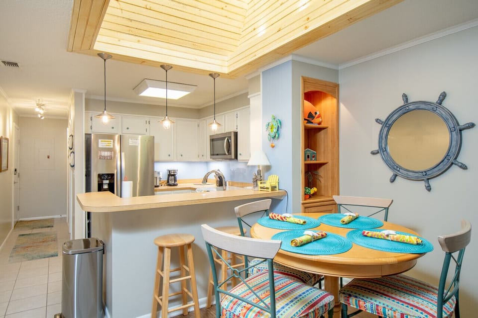 Gather around the table and enjoy meals together in this bright coastal kitchen and dining space