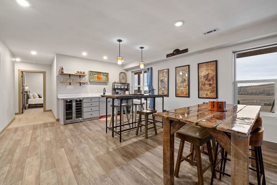 This inviting lower level features a cozy bar area, complete with a sink and mini fridge—perfect for enjoying drinks or snacks in the comfort of your space.