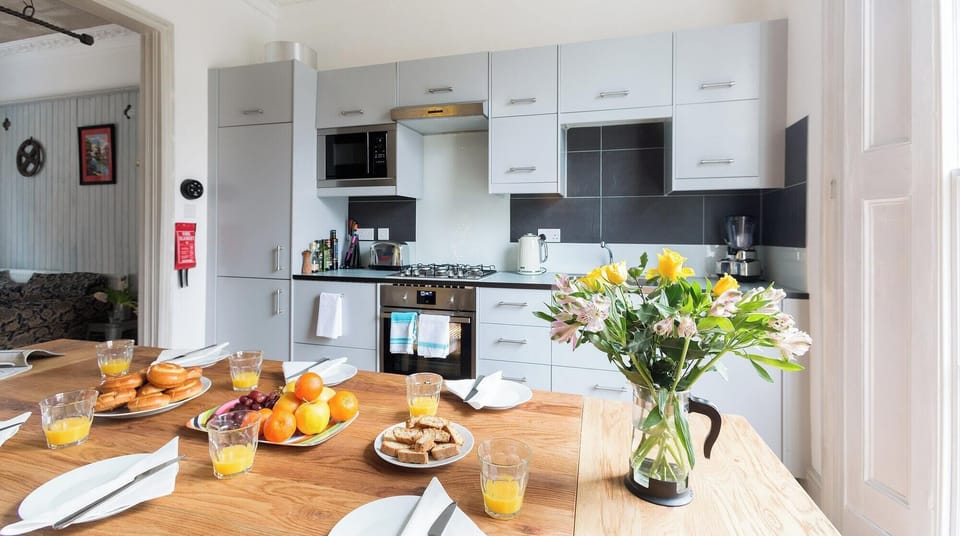 Fitted kitchen with modern appliances, including dishwasher.