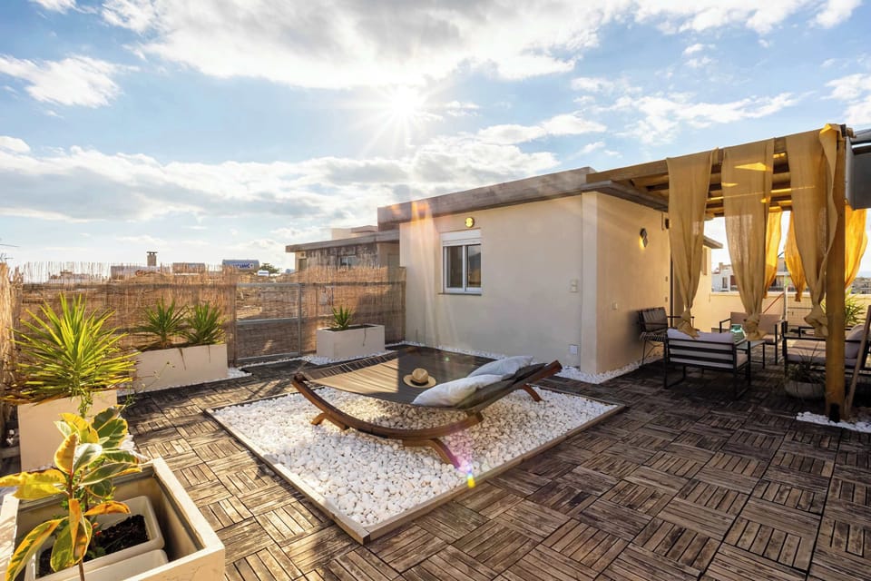 Private Rooftop Oasis with Lounge Chairs and Dining Setup – Ideal for Outdoor Living

