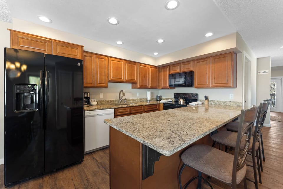 Your fully equipped kitchen with granite counters, stainless appliances, and breakfast bar seating makes meal prep a breeze.