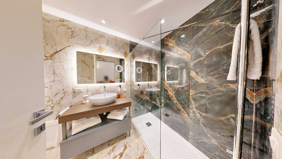 Luxury Suite, Balcony, City View | Bathroom | Shower, hair dryer, bathrobes, slippers