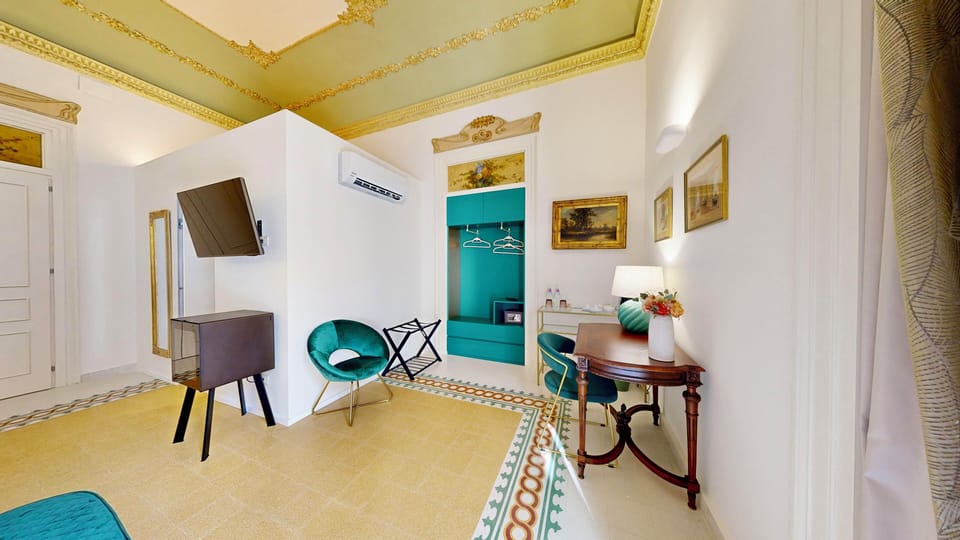 Luxury Suite, Balcony, City View | Minibar, in-room safe, individually furnished, desk