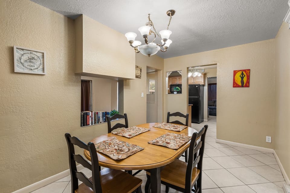 Enjoy meals together at the cozy dining table with comfortable seating for everyone.