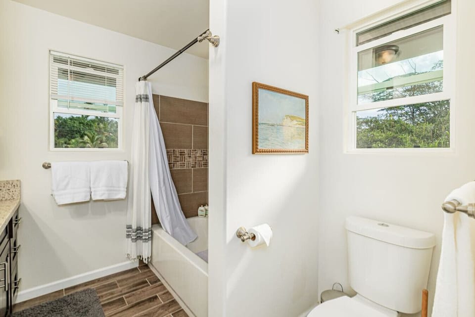 The private primary bathroom includes a tub-and-shower combination, toilet, and natural light.
