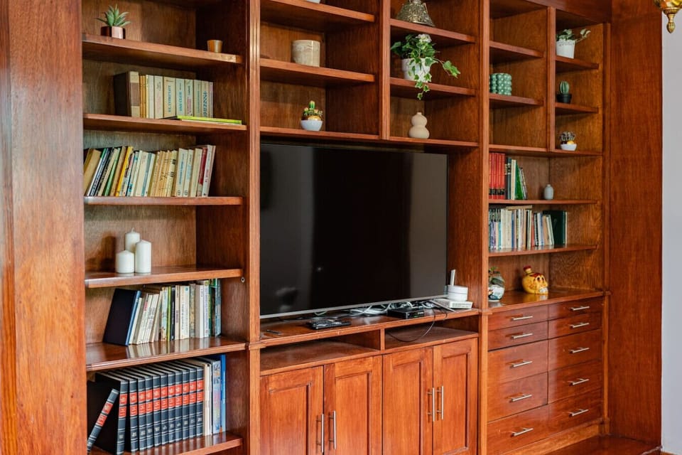 Built-in bookshelves and TV, perfect for movie nights.