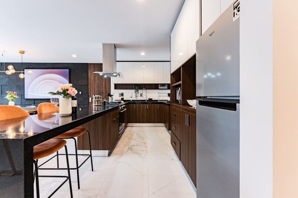 Spacious kitchen with sleek countertops and top-of-the-line appliances.