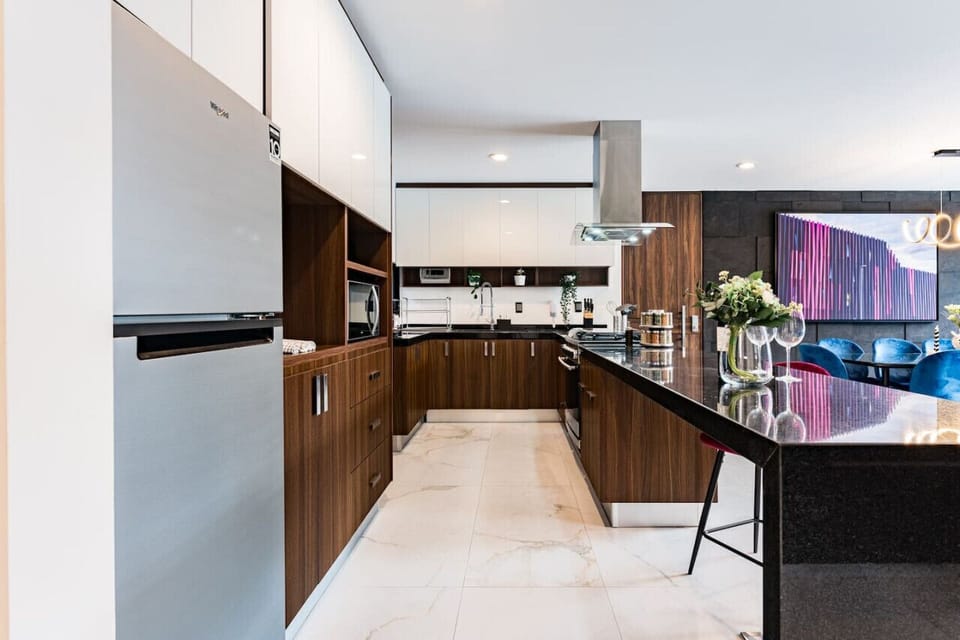 Fully equipped kitchen with rich wood finishes, high-end appliances, and plenty of counter space.