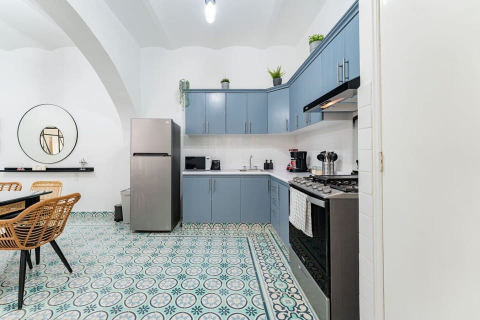 Modern kitchen with blue cabinets.