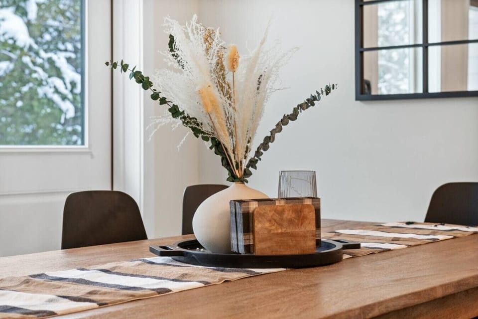 Dining area with plenty of seating for the whole family between the dining table & kitchen island.