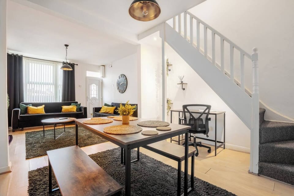 A versatile dining area with a spacious table for shared meals, plus a well-lit workspace so you can stay connected and work comfortably during your stay