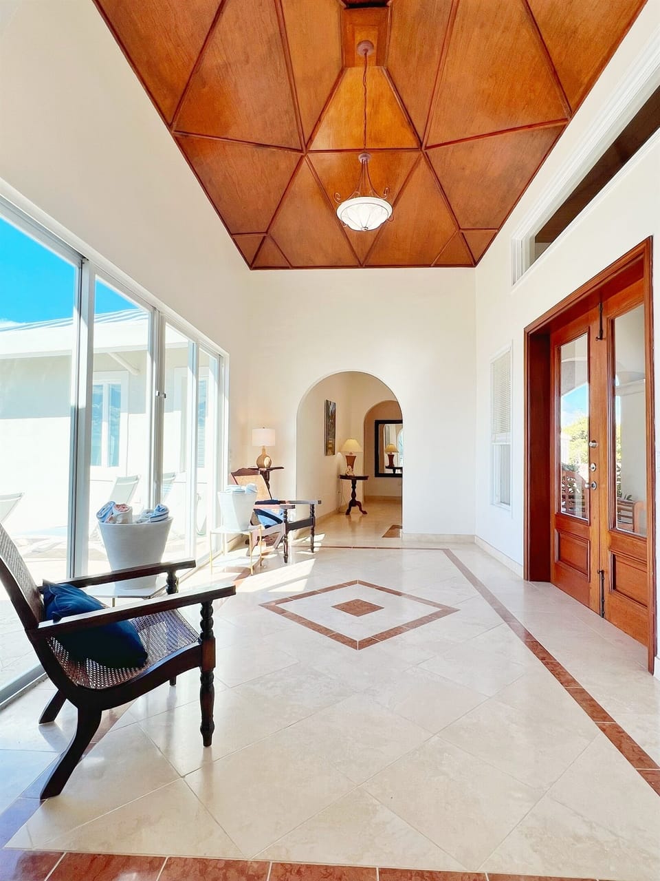 Grand entryways with natural light to greet you each day. Those doors on the left lead straigh out to the pool deck.